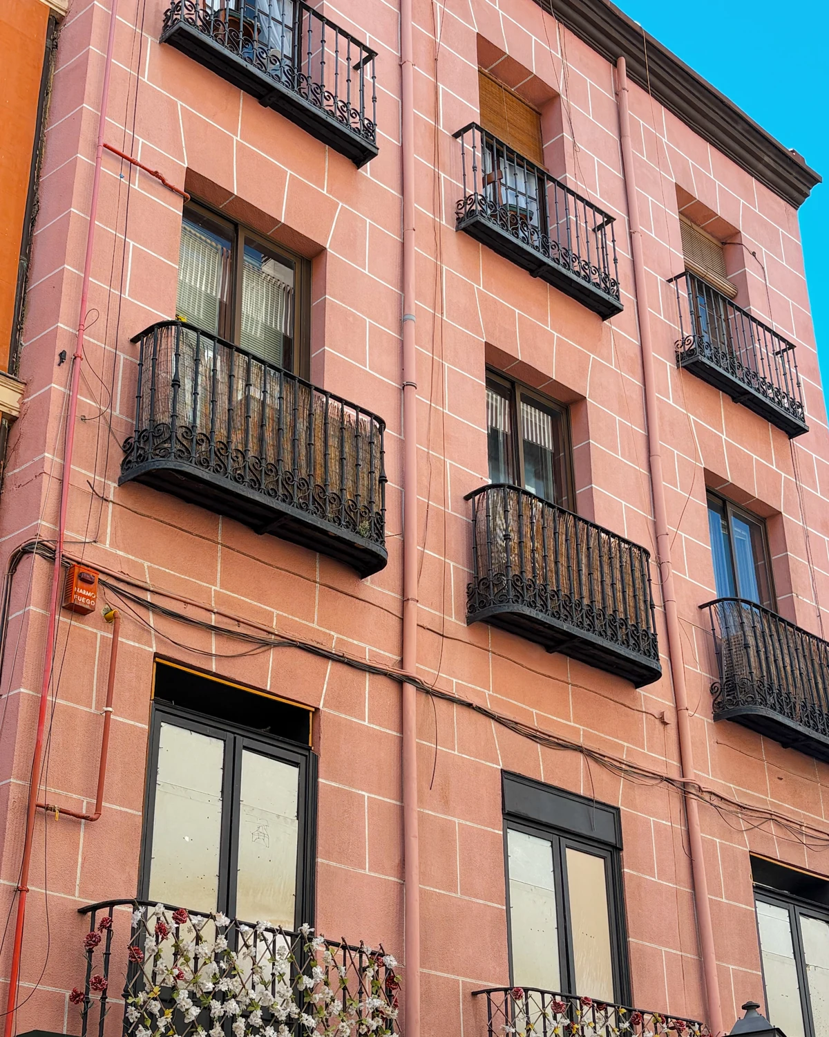 Close crop of a salmon-pink brick building facade