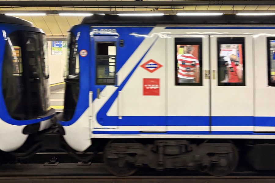 A Madrid Metro train passing the platform in motion blur