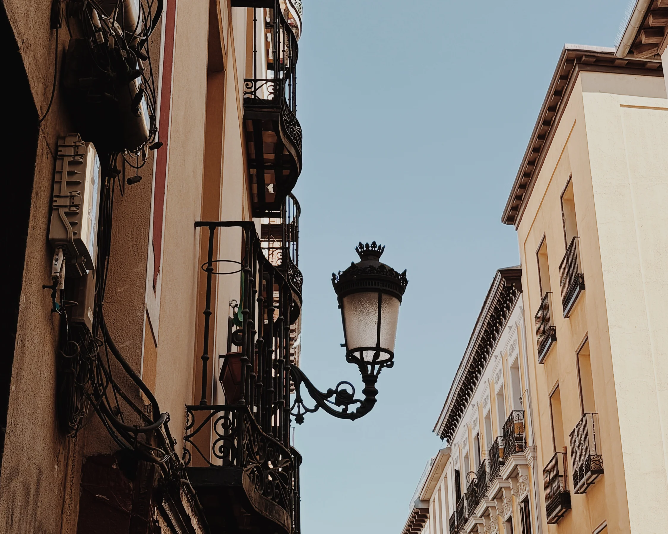 An ornate lamp post against a clear blue sky, Madrid